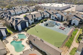 A residential area with a swimming pool and a basketball court.